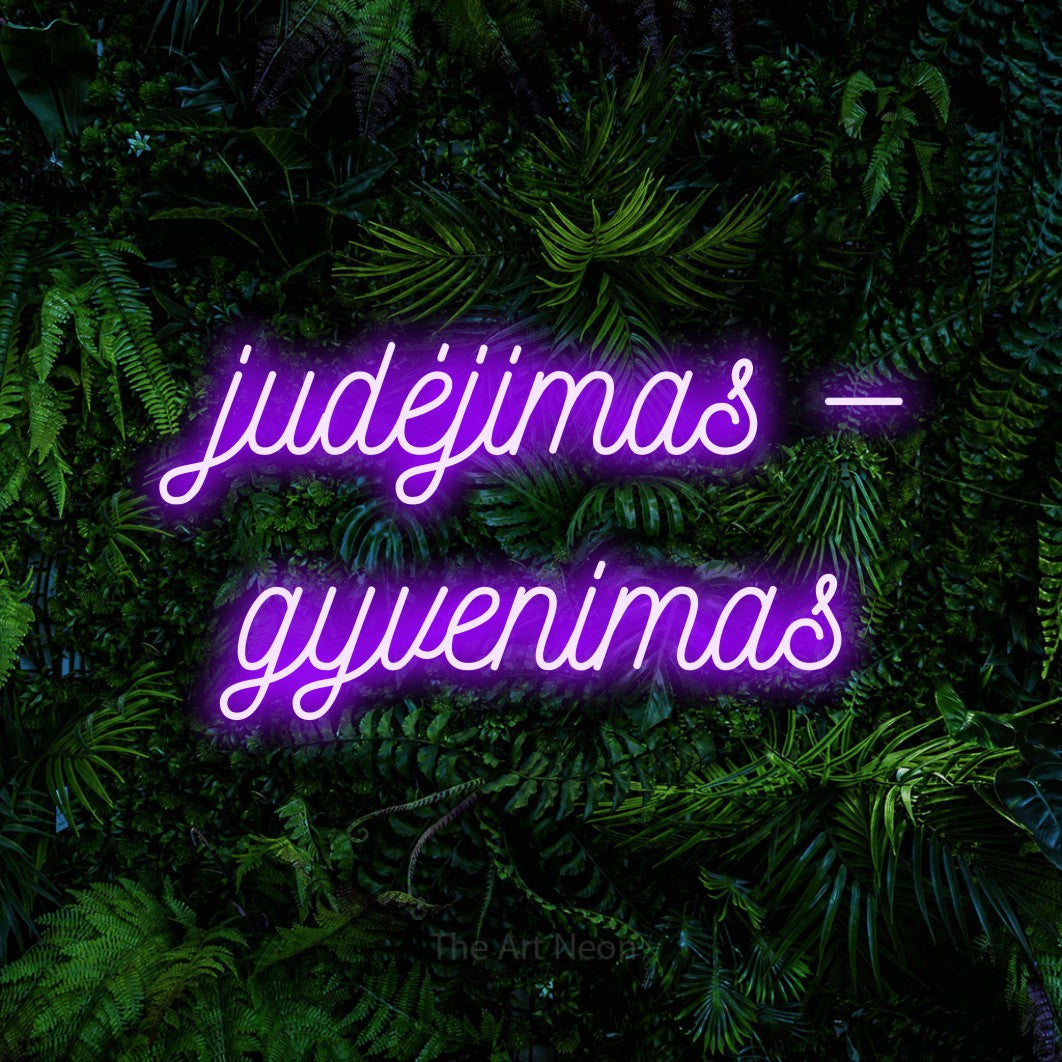 LED neon sign reading “judėjimas — gyvenimas”, arranged in two lines.
