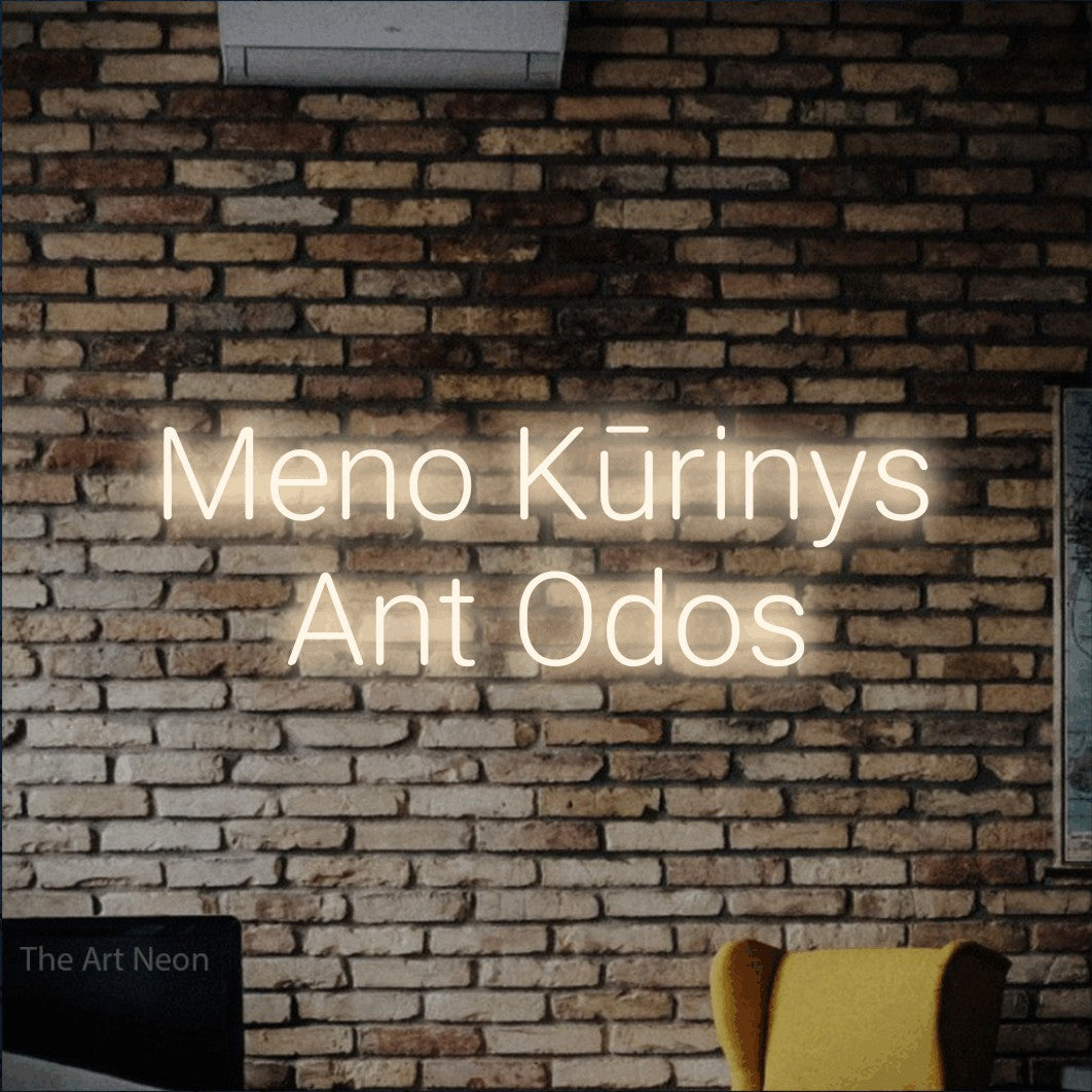 LED neon sign reading “Meno Kūrinys Ant Odos”, arranged in two lines.