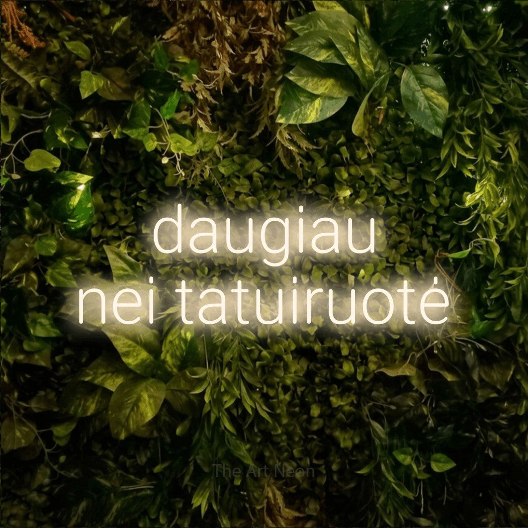 LED neon sign reading “daugiau nei tatuiruotė”, arranged in two lines.