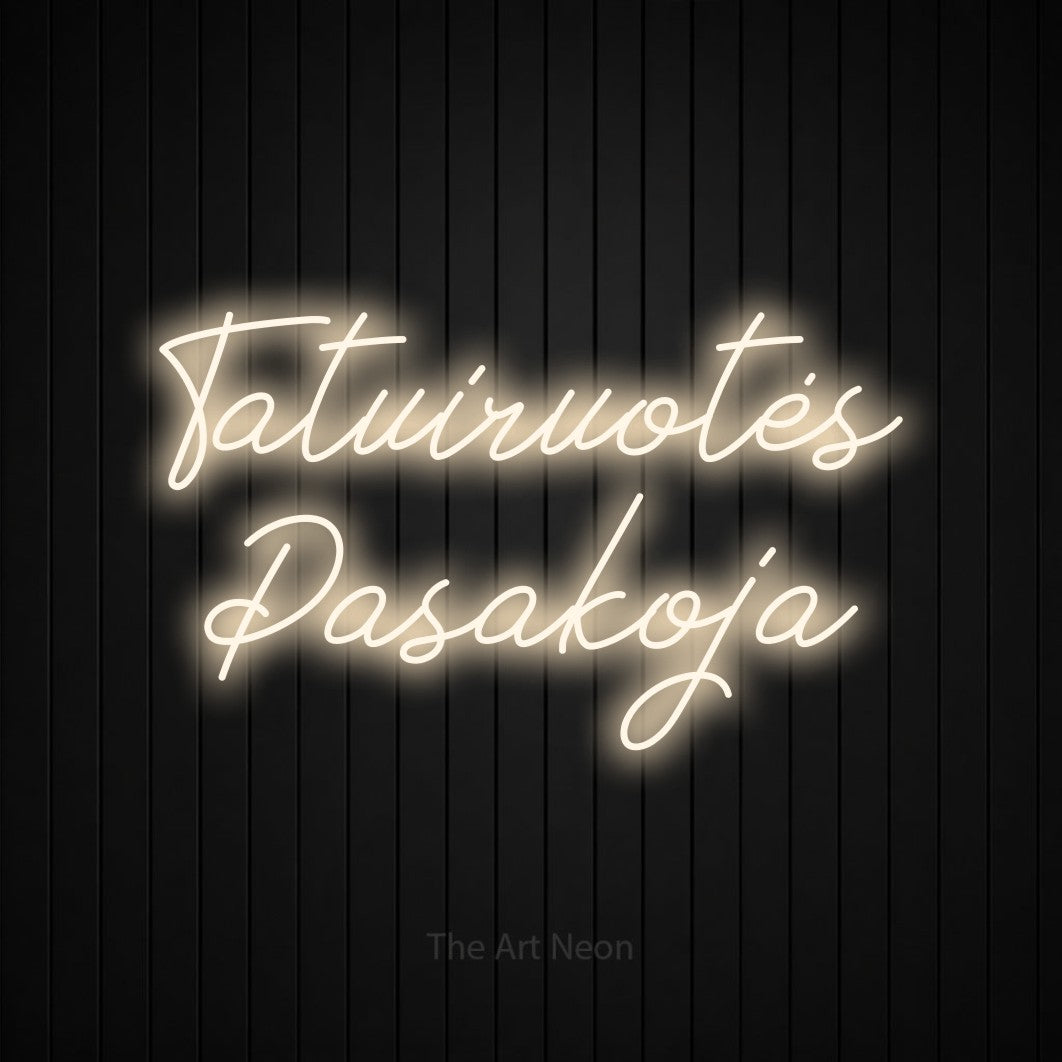 LED neon sign reading “Tatuiruotės Pasakoja”, arranged in two lines.