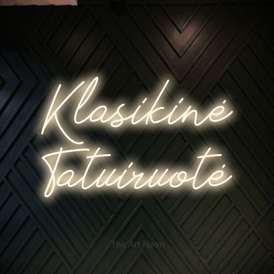LED neon sign reading “Klasikinė Tatuiruotė”, arranged in two lines.