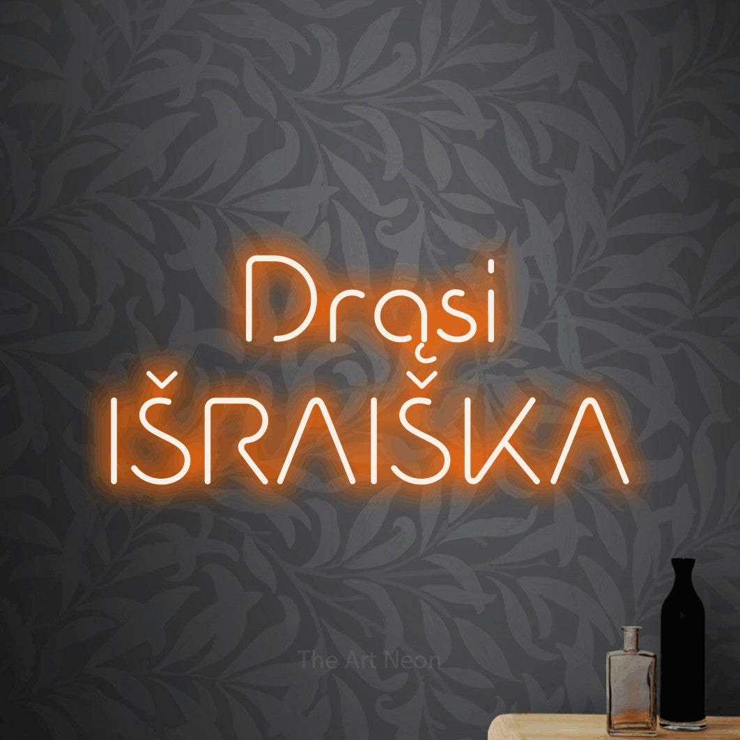 LED neon sign reading “Drąsi IŠRAIŠKA”, arranged in two lines.