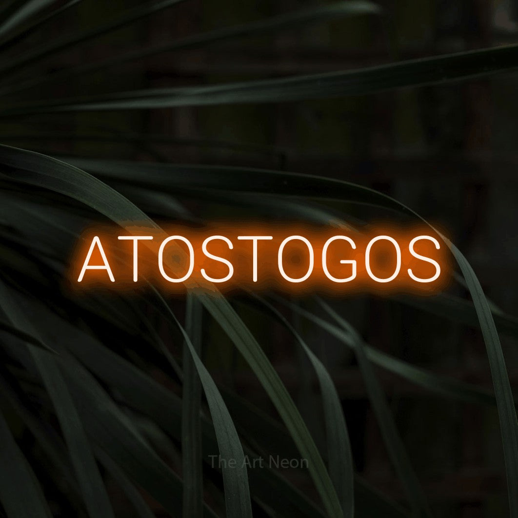 LED neon sign reading “ATOSTOGOS”, arranged in a single line.