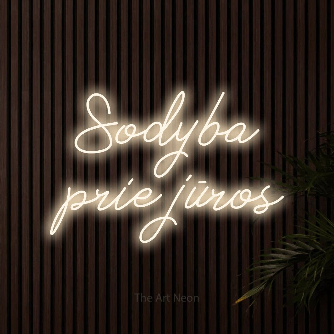 LED neon sign reading “Sodyba prie jūros”, arranged in two lines.