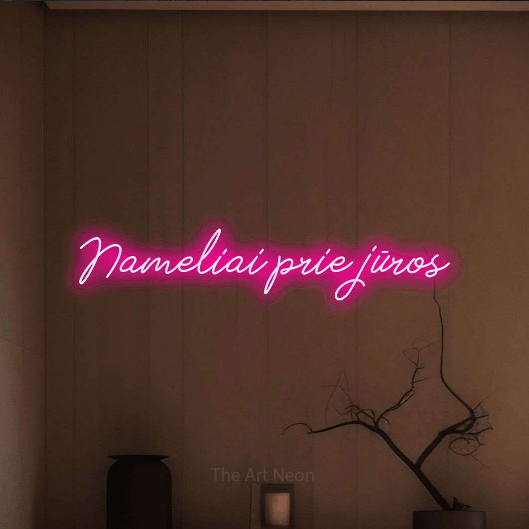 LED neon sign reading “Nameliai prie jūros”, arranged in a single line.