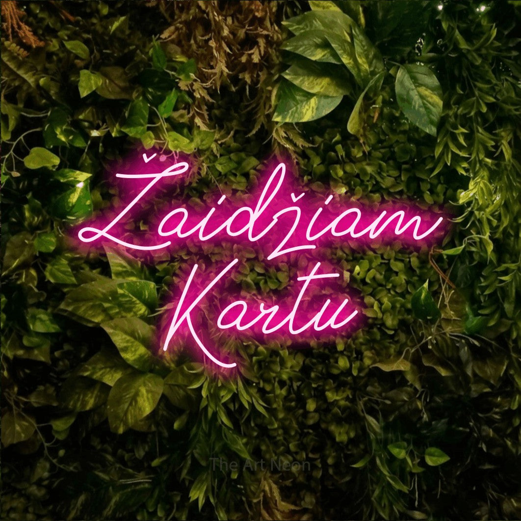 LED neon sign reading “Žaidžiam Kartu”, arranged in two lines.