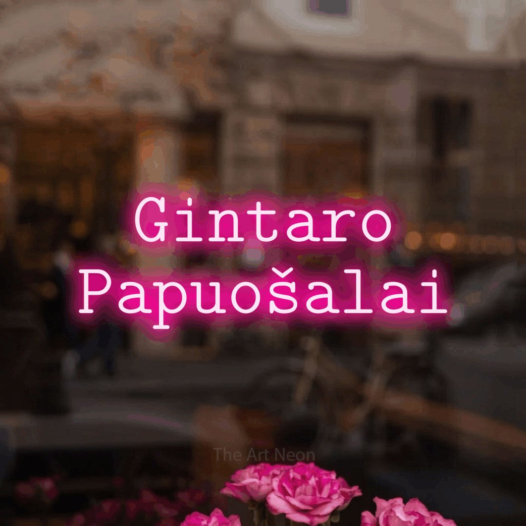 LED neon sign reading “Gintaro Papuošalai”, arranged in two lines.