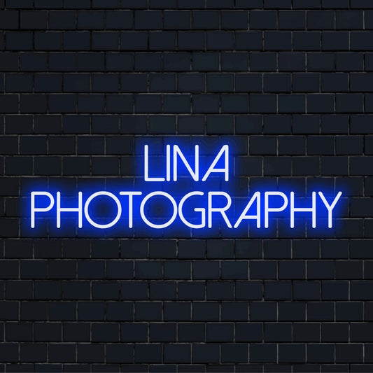 Lina Photography Custom Name Neon Sign, bright neon glow against black brick wall