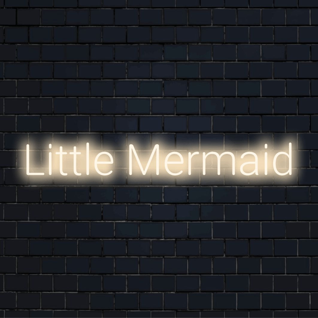 Little Mermaid Neon Sign, bright neon lettering on dark brick background