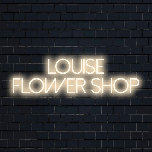 Louise Flower Shop Personalized Neon Light with bright neon lettering on black brick background
