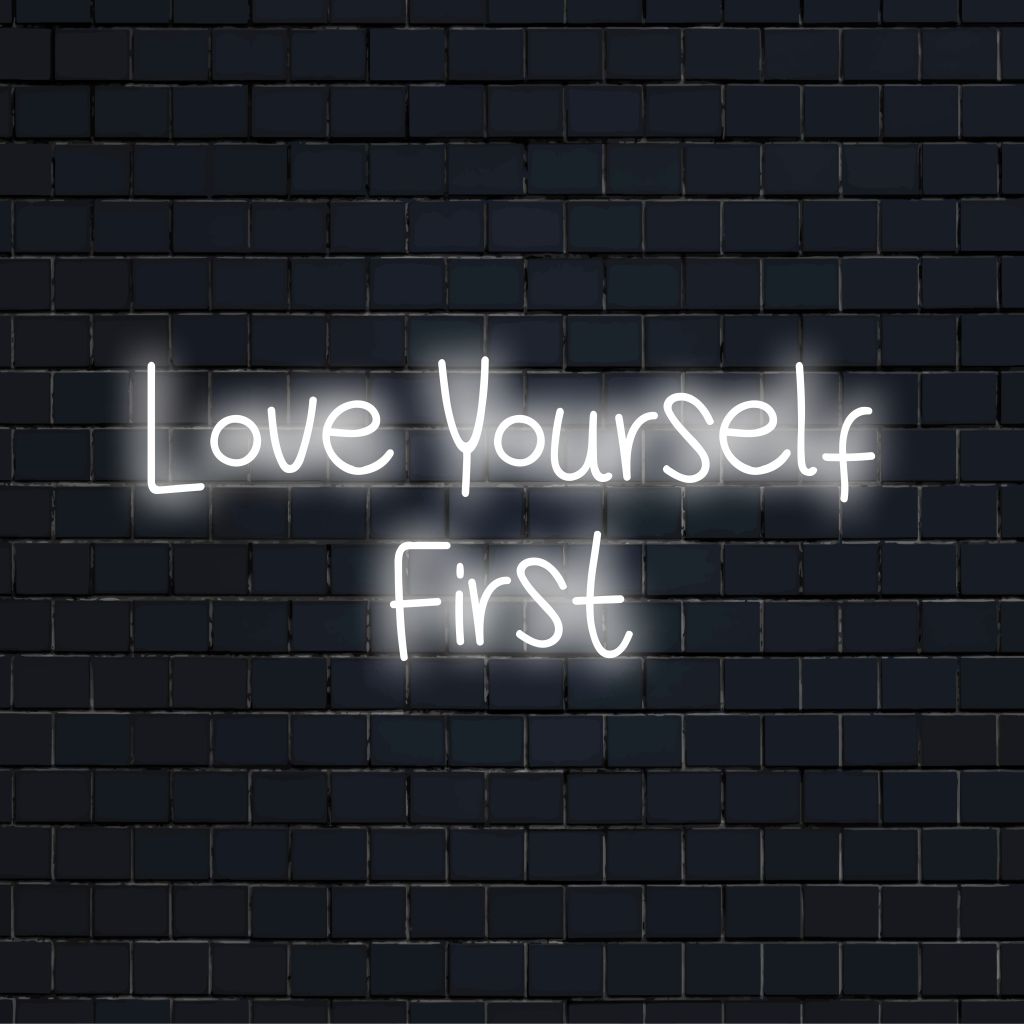 Love Yourself First LED Neon Sign, bright neon glow against black brick wall