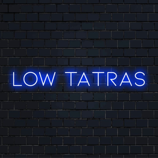 Low Tatras Neon Light with glowing wall decor against black brick wall