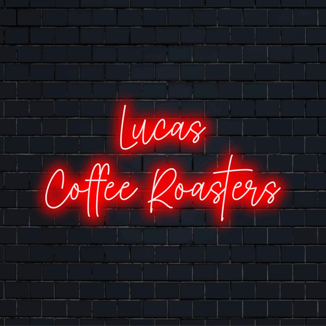 Custom red LED neon coffee shop lettering displayed on a dark brick wall