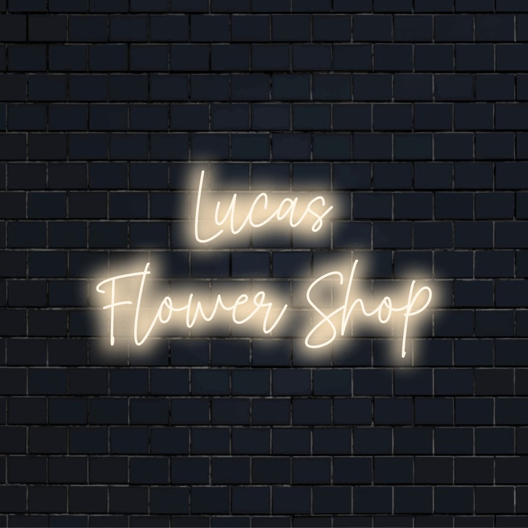 Lucas Flower Shop Custom Name Neon Sign, glowing wall decor against black brick wall