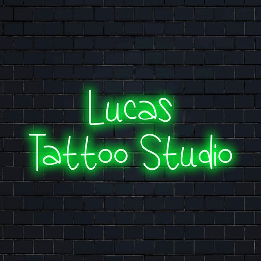 Lucas Tattoo Studio Custom Name Neon Sign, glowing wall decor on dark brick wall