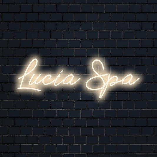 Lucia Spa Custom Name Neon Sign, bright LED glow on dark brick wall