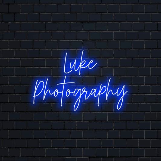 Luke Photography Personalized LED Neon Sign, glowing neon text on dark brick wall