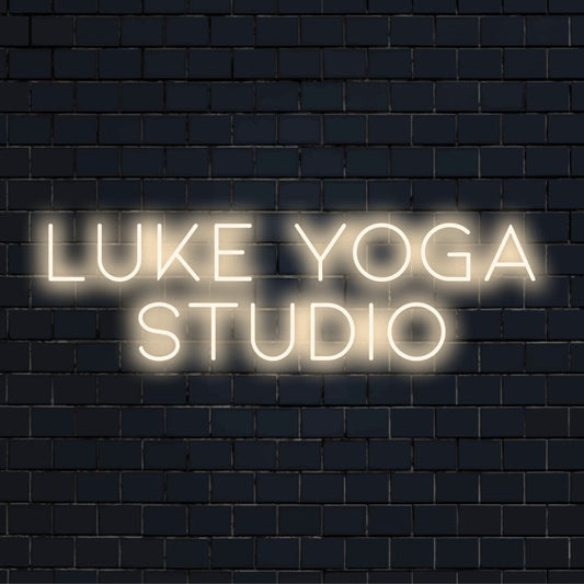 Luke Yoga Studio Personalized Neon Light with glowing wall decor on dark brick background