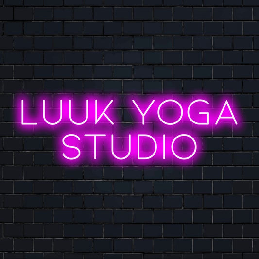 Luuk Yoga Studio Personalized Neon Light with glowing neon text on dark brick wall