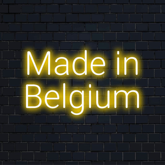 Made In Belgium Neon Light with bright neon glow against brick backdrop