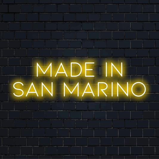 Made In San Marino Neon Light with glowing wall decor on dark brick background