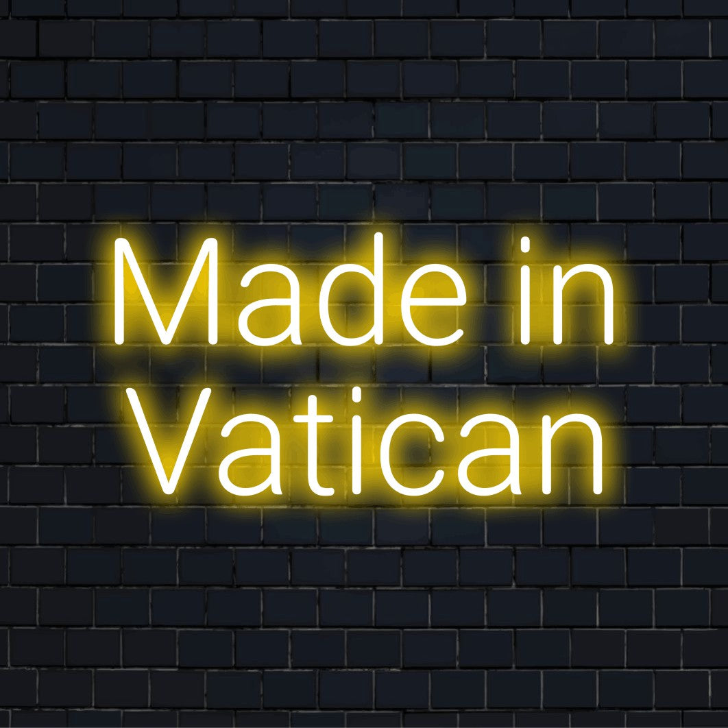 Made In Vatican Neon Light with neon text light against black brick wall