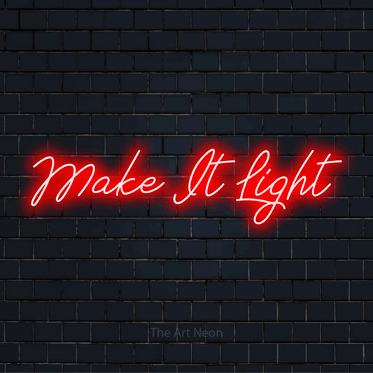 "Make It Light" script-style LED neon sign on a black brick wall