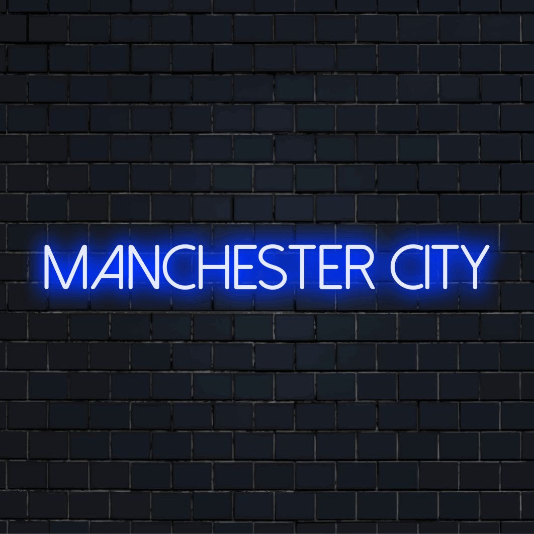Manchester City Neon Sign, bright neon lettering on dark brick wall