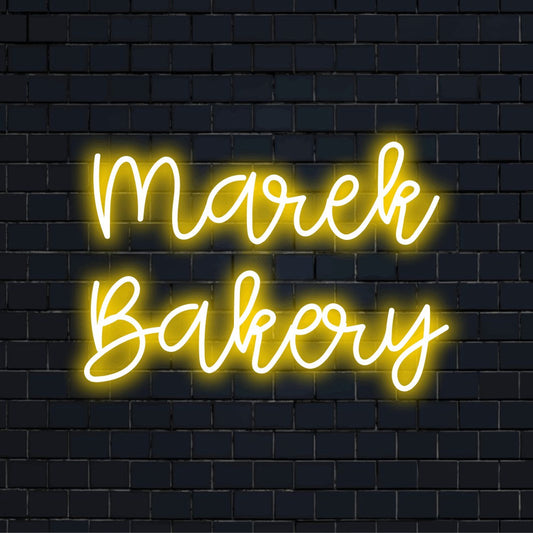 Marek Bakery Personalized LED Neon Sign, glowing lettering on black brick background