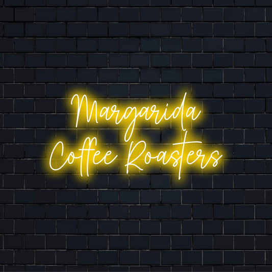 Margarida Coffee Roasters Personalized Neon Light with neon text light against brick backdrop