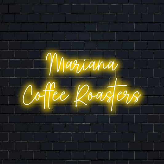 Mariana Coffee Roasters Personalized LED Neon Sign, glowing wall decor against black brick wall