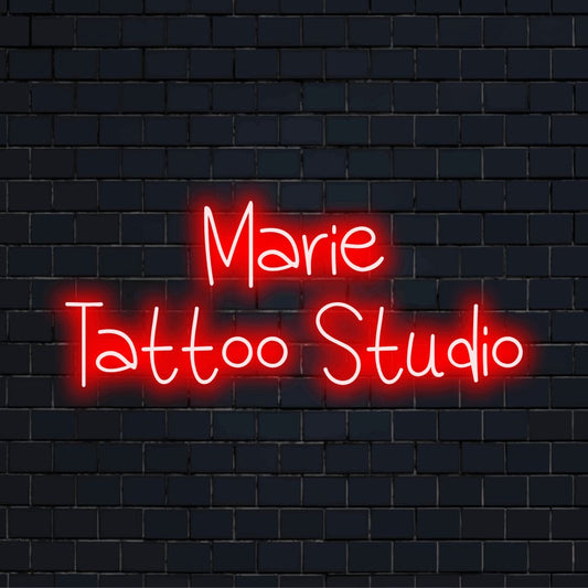 Marie Tattoo Studio Personalized LED Neon Sign, glowing neon text on dark brick background