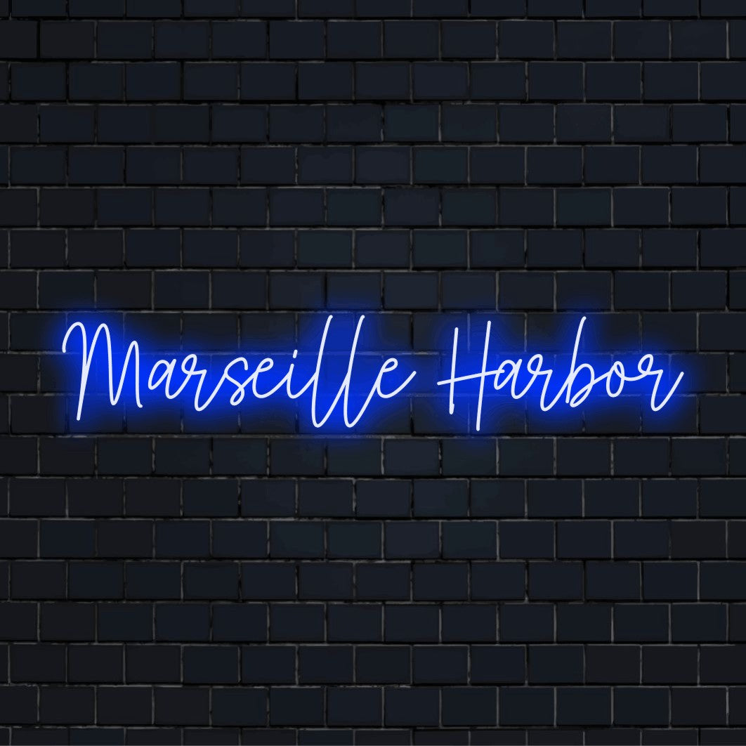 Marseille Harbor Neon Sign, bright neon lettering on dark brick wall