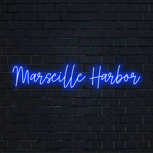 Marseille Harbor Neon Sign, bright neon lettering on dark brick wall