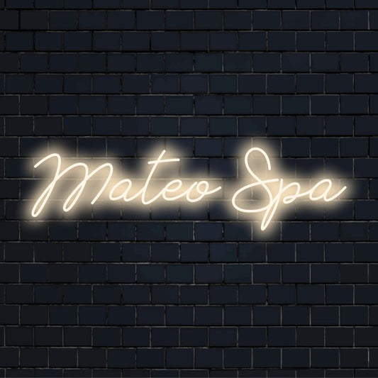 Mateo Spa Personalized Neon Light with bright neon lettering on dark brick wall