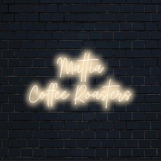 Mattia Coffee Roasters Personalized LED Neon Sign, glowing neon text against black brick wall