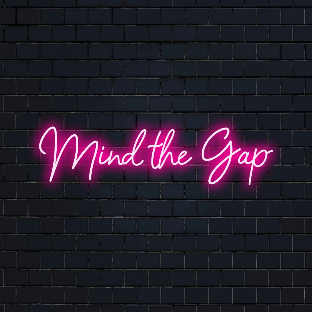 Mind The Gap Neon Sign, neon text light on dark brick wall