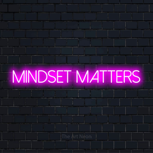 "Mindset Matters" script-style LED neon sign on a black brick wall