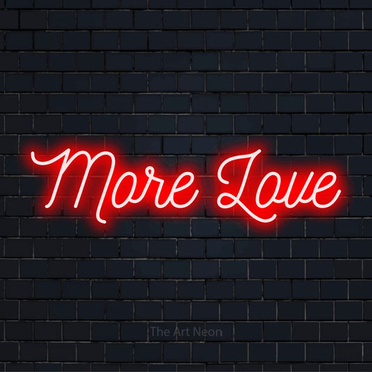 "More Love" LED neon sign on a black brick wall