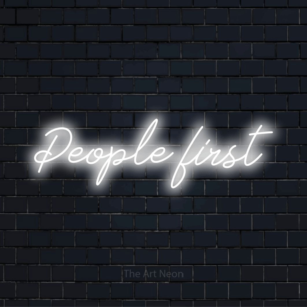 "People First" text design with neon effect on a black brick wall
