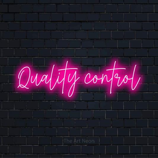 "Quality Control" neon text design on a black brick wall