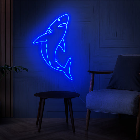The shark neon sign is a bold addition to ocean-themed decor, illuminating with a fierce and captivating light.