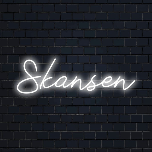 Skansen Neon Light with glowing lettering against brick backdrop