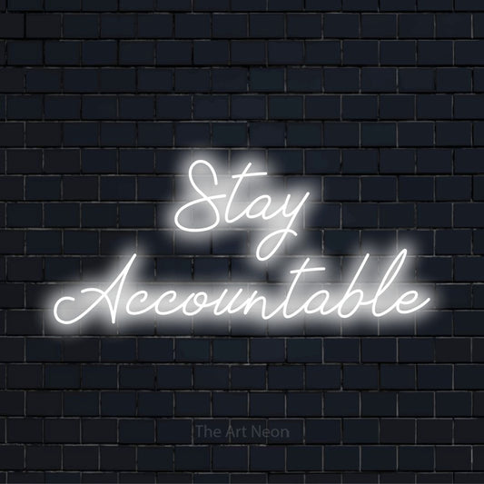 "Stay Accountable" glowing LED neon sign on a black brick wall
