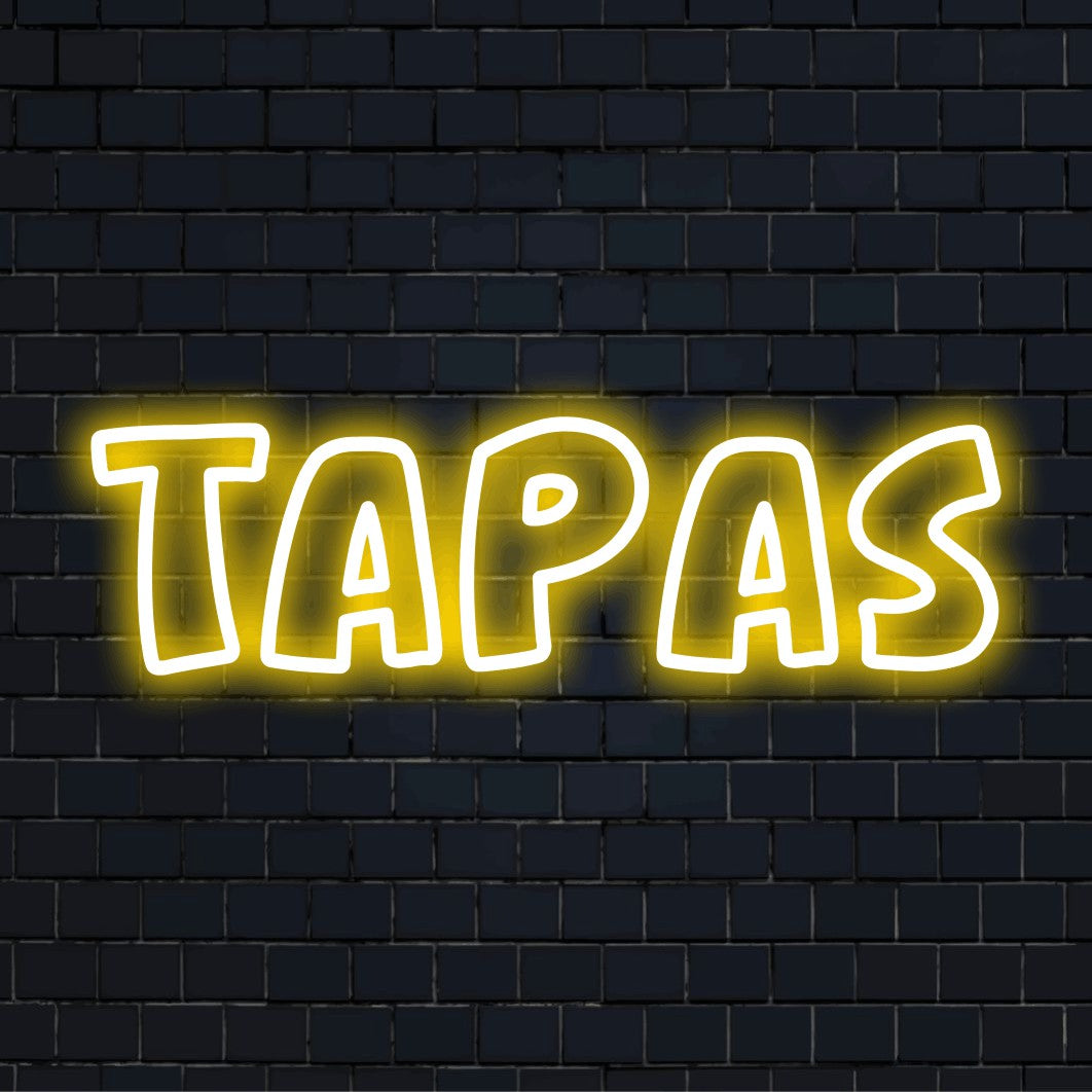 Tapas Neon Sign, glowing wall decor against brick backdrop