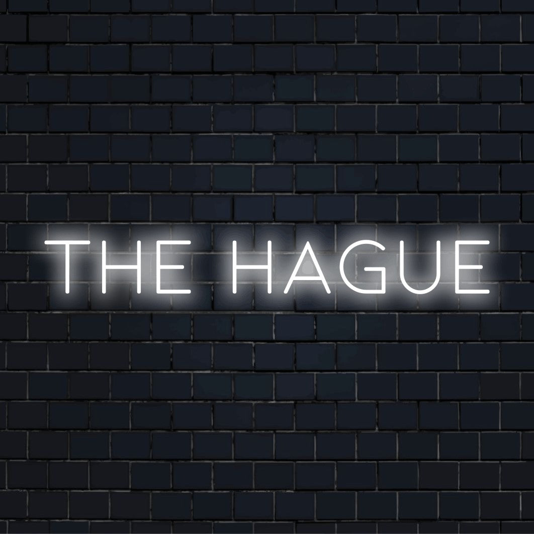 The Hague LED Neon Sign, bright neon lettering on dark brick background