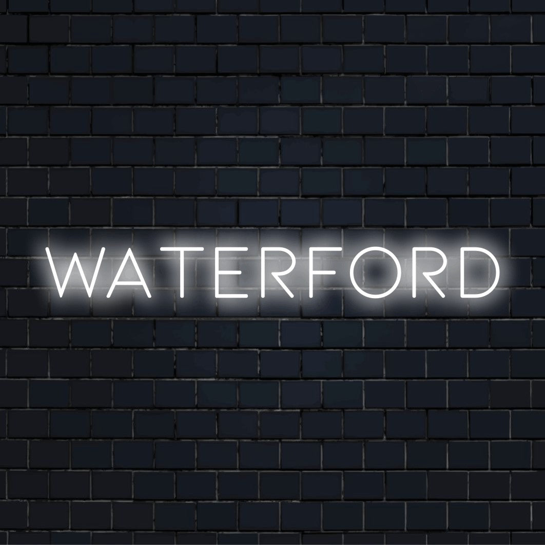 Waterford Neon Sign, glowing neon text on dark brick background