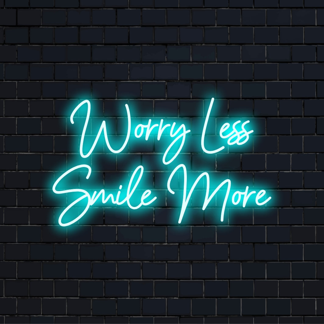 Worry Less Smile More LED Neon Sign, glowing lettering on black brick background