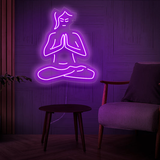 A mesmerizing neon sign featuring a silhouette of a woman deep in Zen meditation, radiating a peaceful and serene light